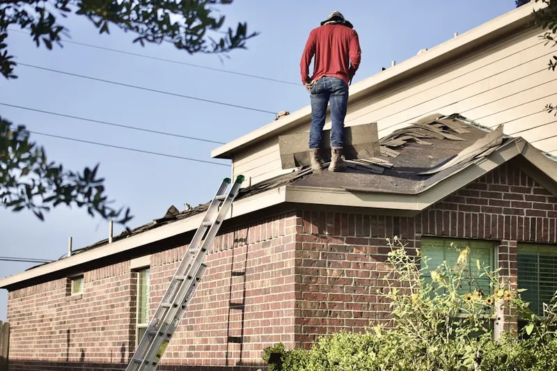 Professional roofer working on a residential roof in Wendell